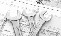 Three wrenches on blue prints used for plumbing services in the South Lake Macquarie area